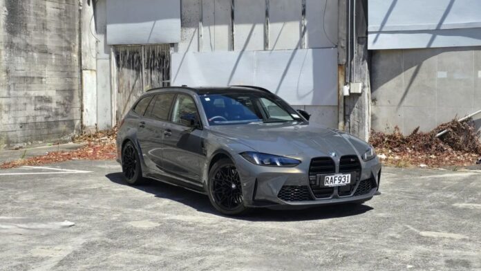 Sleek and aggressive BMW M3 Competition Touring with bold kidney grille, sharp LED headlights, and muscular body lines.